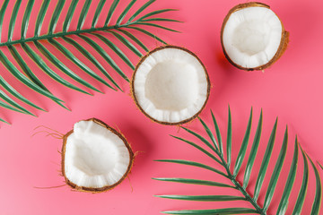 Coconut halves on a bright pink background