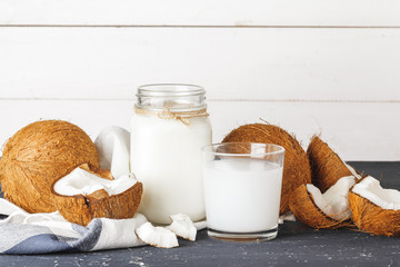 Coconut and  glass of coconut milk on  wooden background