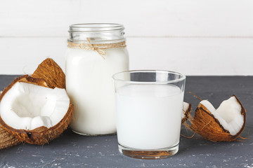 Coconut and  glass of coconut milk on  wooden background