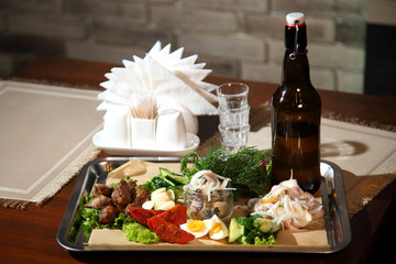 Horseradish vodka and snack vegetables. Homemade horseradish vodka with traditional snack. 