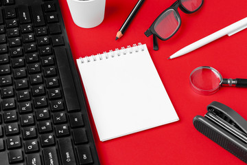 Set of stationery items on red office desk