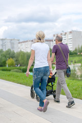 Family in the sity with a stroller.