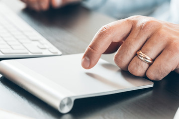 Businessman hand using touch pad of laptop close up