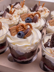 Set of desserts decorated with berries and cookies.