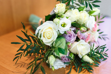 bright wedding bouquet of summer white pink roses  with wedding rings