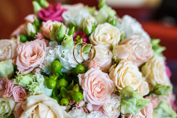 bright wedding bouquet of summer white pink roses  with wedding rings