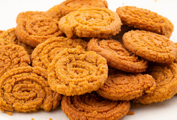 Indian Traditional Snack Chakli, a spiral shaped crisp deep fried snack, It is known as  Chakali, Murukku, Muruku, Murkoo, Chakri in Gujarat, Chakli in Maharashtra and Northern India