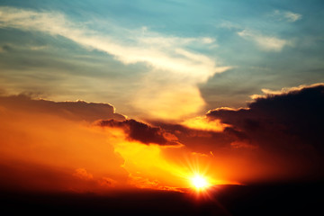 Fototapeta premium bright Red sunset rich in dark clouds, rays of light