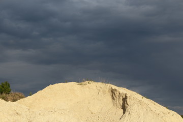 mountain on a quarry and dark clouds