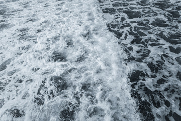 Top view of beautiful rough dark foamy blue sea surface. Horizontal color photography.