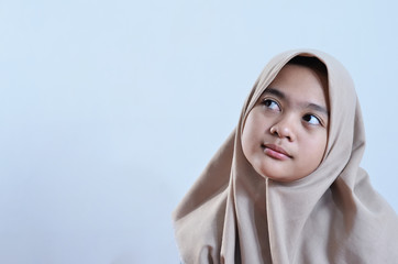 Portrait of a happy young muslim woman look at blank area for sign or copyspace