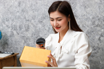 Young teenage prepare to send goods to customer after checking order, work at home.