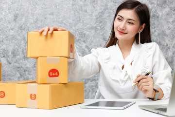 Young teenage prepare to send goods to customer after checking order, work at home.