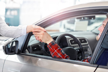 Man buying new car in salon