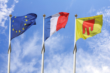 Europeen, French and Auvergne flags with blue sky in background