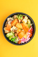 Container with delicious food on color background