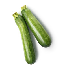 Fresh zucchini squashes on white background