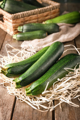 Fresh zucchini squashes on wooden table