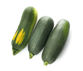 Fresh zucchini squashes on white background