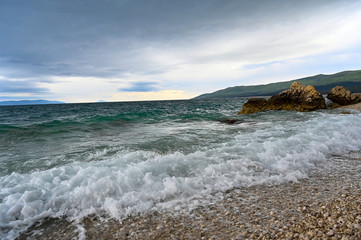 waves coming and going on a pebbely beach