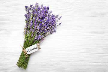Beautiful lavender flowers on white wooden background