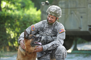 Soldier with military working dog outdoors