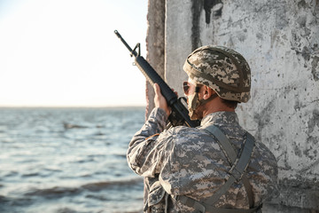 Male soldier in ambush outdoors