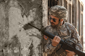 Male soldier in ambush outdoors