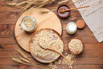 Oat flakes with milk and honey on wooden table