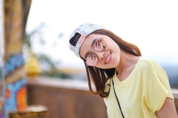 Portrait of Asian woman wearing sunglasses and cap