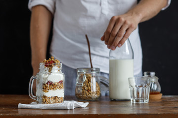 The glass of granola with dried berries and yogurt.
