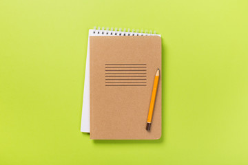 school notebook on a green background, spiral notepad on a table.