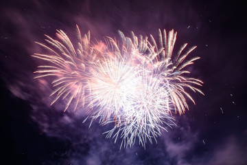 Beautiful pyrotechnic fireworks at night over the water. Celebration.