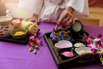Obraz na płótnie Canvas Asian woman testing salt scrub for massage at spa.