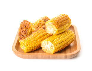 Plate with tasty grilled corn cobs on white background