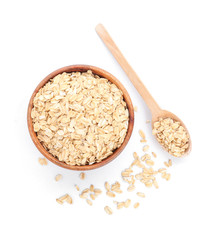 Bowl and spoon with raw oatmeal on white background