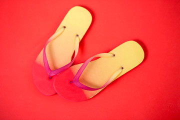 Beach flip flop on red background