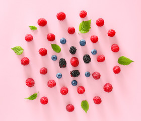 Tasty ripe berries on color background