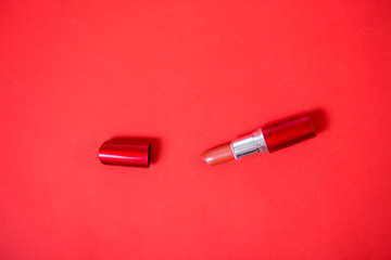 Lipstick isolated on red background