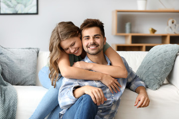 Portrait of happy loving couple at home