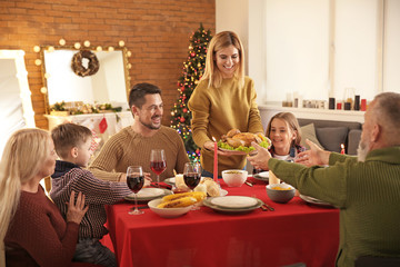 Happy family having Christmas dinner at home