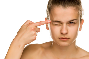 Obraz premium young beautiful woman touches her forehead on white background