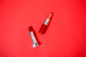 Lipstick isolated on red background