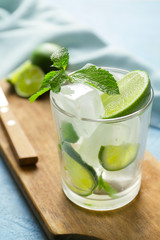 Glass of fresh mojito on table