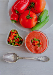 Gazpacho, tomato soup made from made of raw blended vegetables. Traditional Spanish cold soup on wooden table.