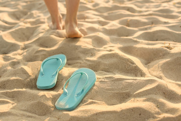 Fototapeta na wymiar Flip-flops on sand beach at resort
