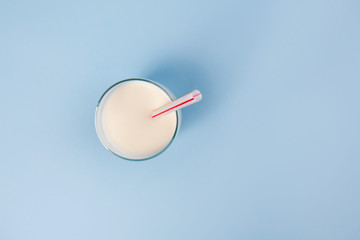 Glass of fresh milk on color background