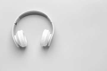 Modern headphones on light background