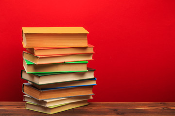  pile of old books, panorma, good copy space  on red background