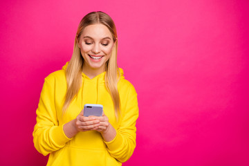 Pretty lady holding telephone hands wear yellow hoodie pullover isolated pink background
